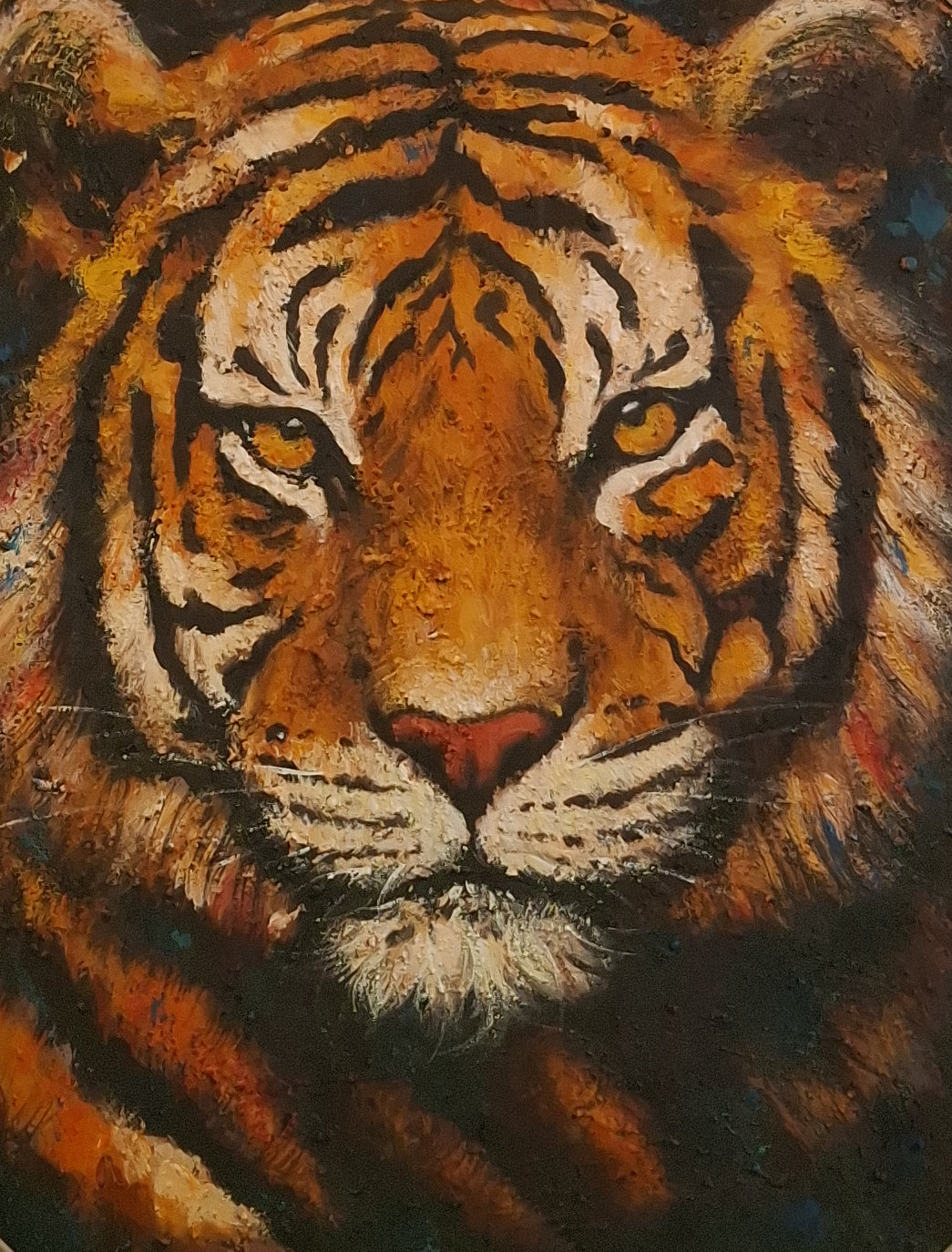 Close-up of a tiger's face with detailed fur and stripes.