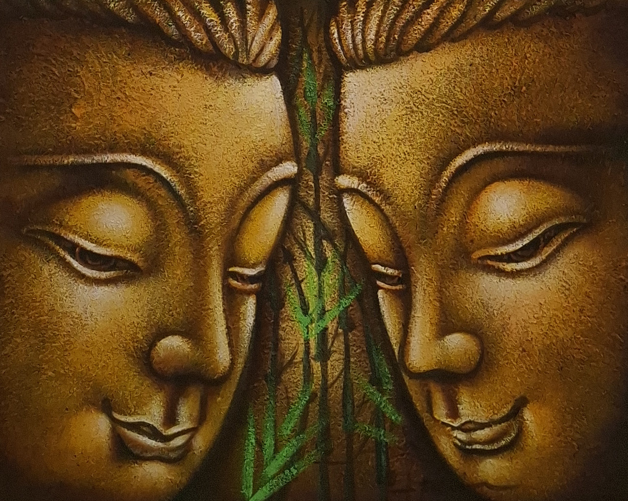 Bronze sculpture of two faces with a green leaf between them