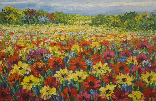 Colorful field of flowers with a landscape in the background